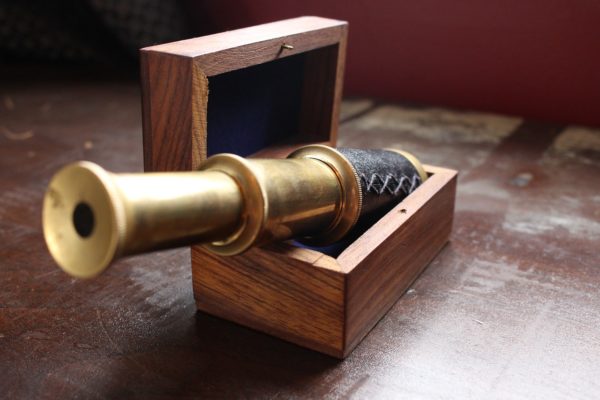 A telescope inside a wooden box