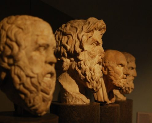 Four stone busts of philosophers.