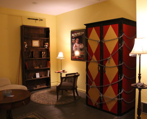 Photo of a magician's dressing room with a large, locked-up cabinet