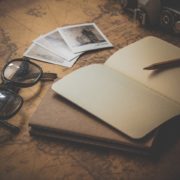 Photo of a notebook and glasses on a map