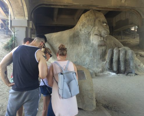 Players reading a clue next to the Fremont Troll
